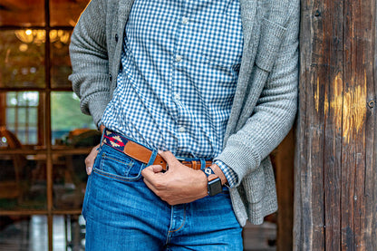 Navy blue, red, and beige patterned brown leather belt with a nickle metal buckle.