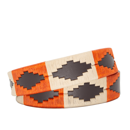 A brown leather belt with a burnt orange and khaki woven geometric pattern and solid brass buckle.