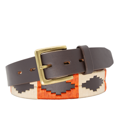 A brown leather belt with a burnt orange and khaki woven geometric pattern and solid brass buckle.