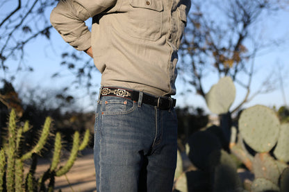 A black leather belt with a black, white, khaki & red woven geometric pattern and nickel-matte solide brass buckle.