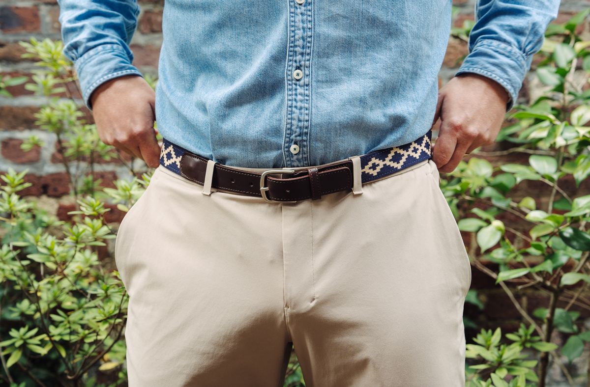 Brown leather belt with a navy and beige geometric woven pattern.