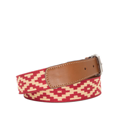 A brown leather belt with a red and beige woven geometric pattern and solid brass buckle.