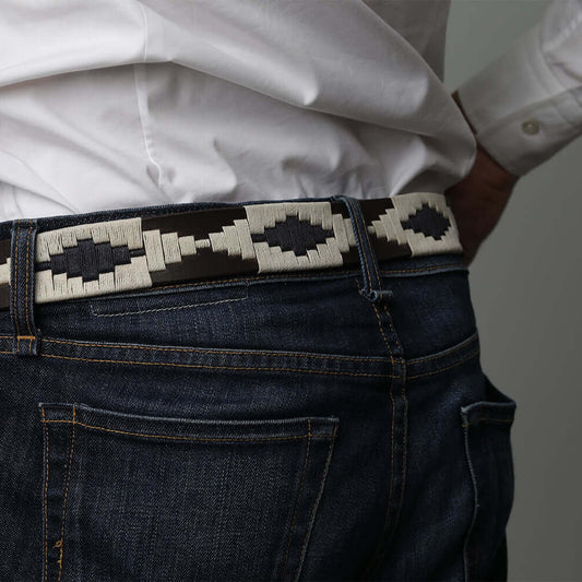 A brown leather belt with a Navy & Light Khaki woven geometric pattern and gold metal buckle.