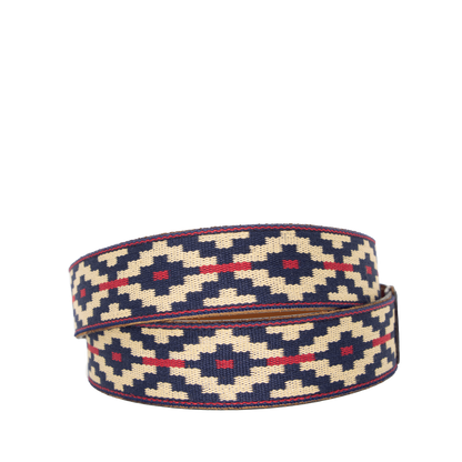 A cognac brown leather belt with a navy, kahki and red woven geometric pattern and solid brass buckle.